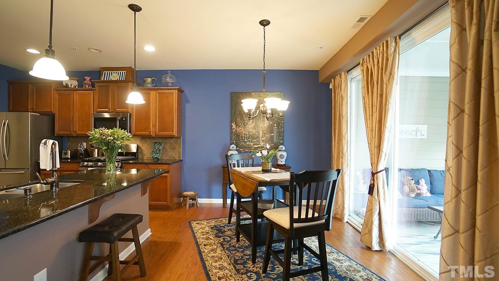 10115 Barnhart Way Raleigh, NC 27617 - Photo 14 of 60 a dining room with furniture and window