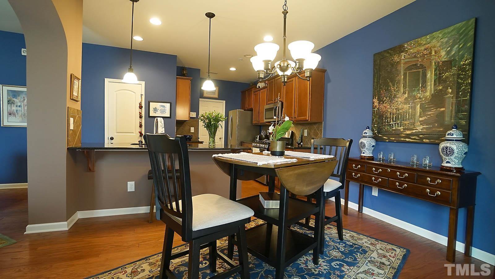 10115 Barnhart Way Raleigh, NC 27617 - Photo 15 of 60 a view of a dining room with furniture and chandelier