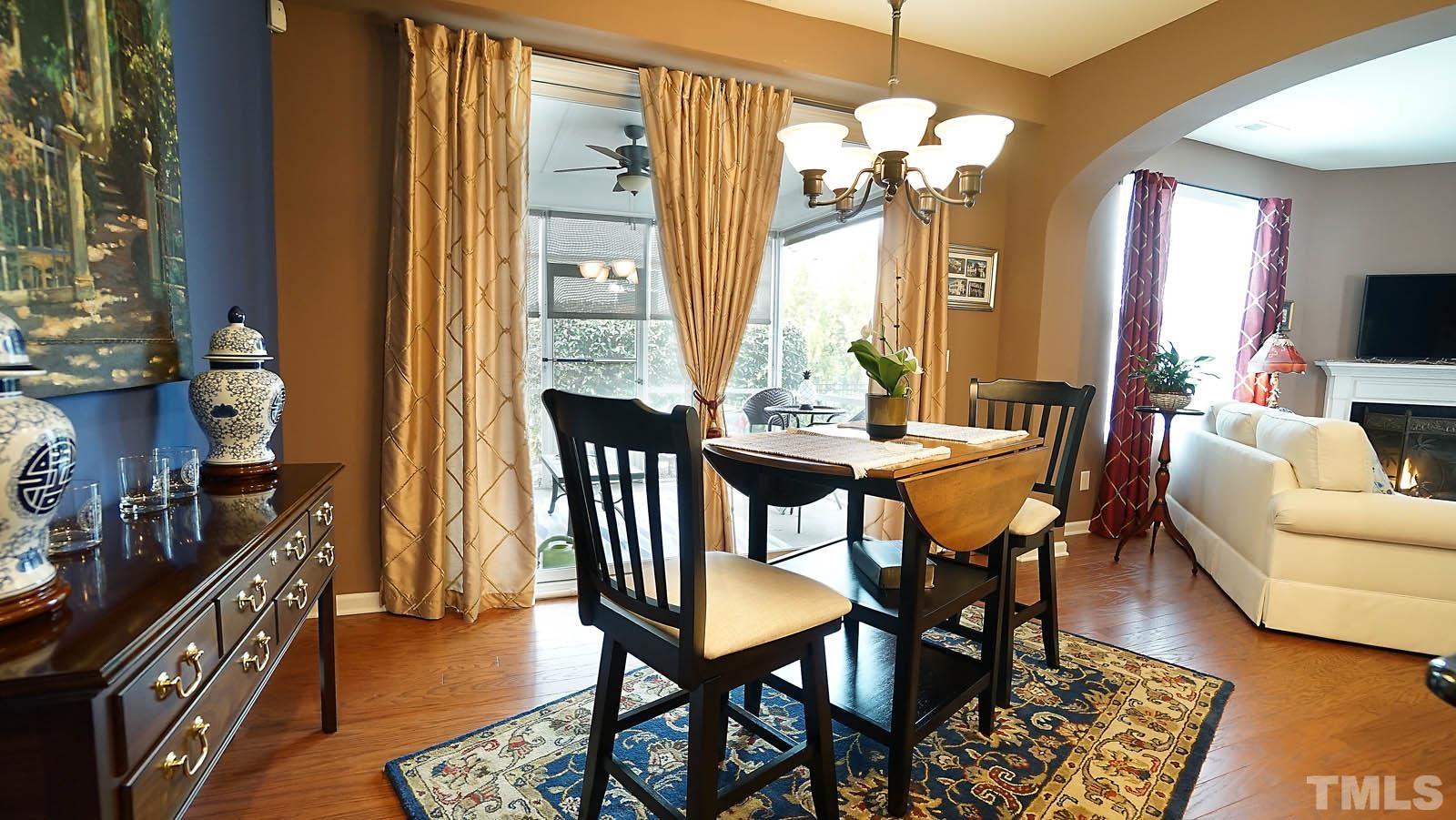 10115 Barnhart Way Raleigh, NC 27617 - Photo 17 of 60 a view of a dining room with furniture and a chandelier
