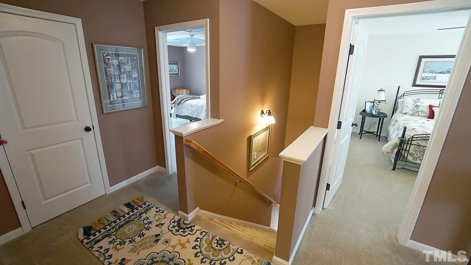 10115 Barnhart Way Raleigh, NC 27617 - Photo 28 of 60 a view of a hallway with workspace and wooden floor