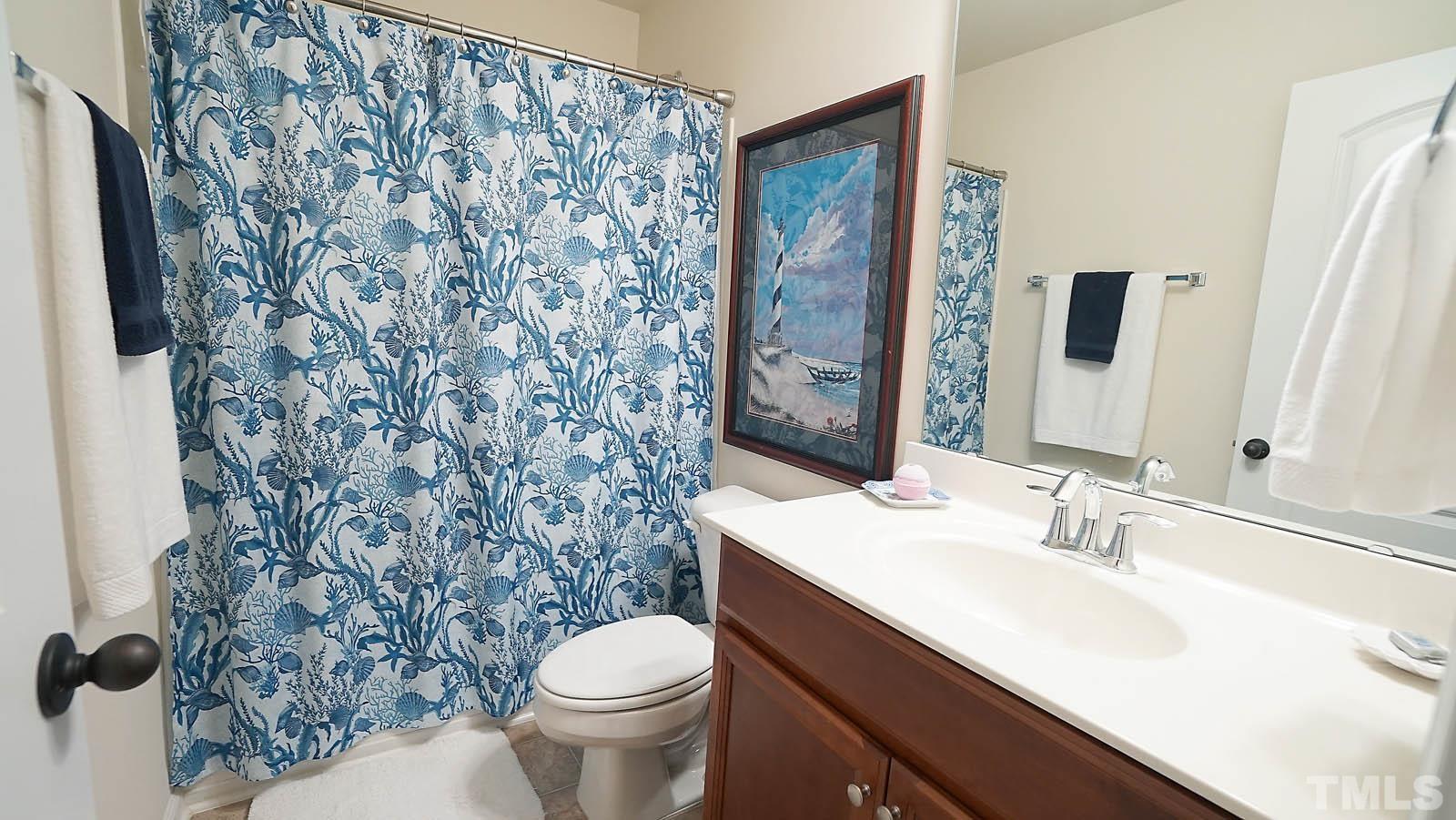 10115 Barnhart Way Raleigh, NC 27617 - Photo 31 of 60 a bathroom with a sink toilet and shower