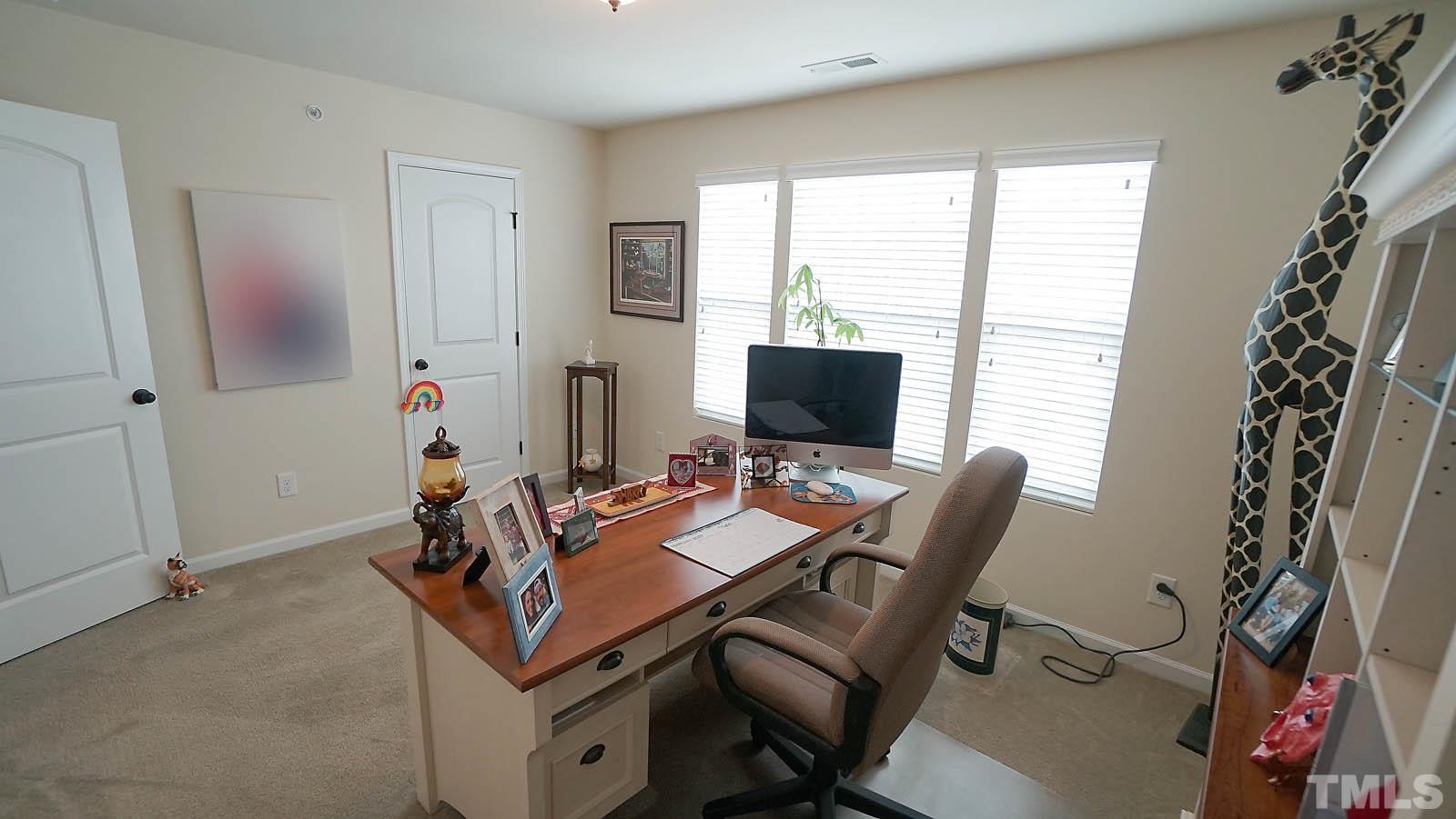 10115 Barnhart Way Raleigh, NC 27617 - Photo 36 of 60 a view of a workspace with furniture and a window