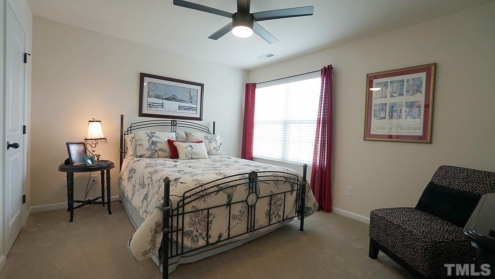 10115 Barnhart Way Raleigh, NC 27617 - Photo 37 of 60 a bedroom with a bed chair and window