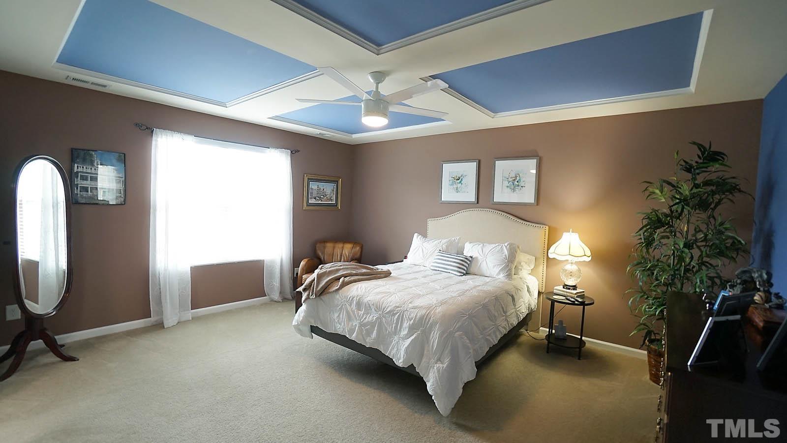 10115 Barnhart Way Raleigh, NC 27617 - Photo 38 of 60 a bedroom with bed and a potted plant
