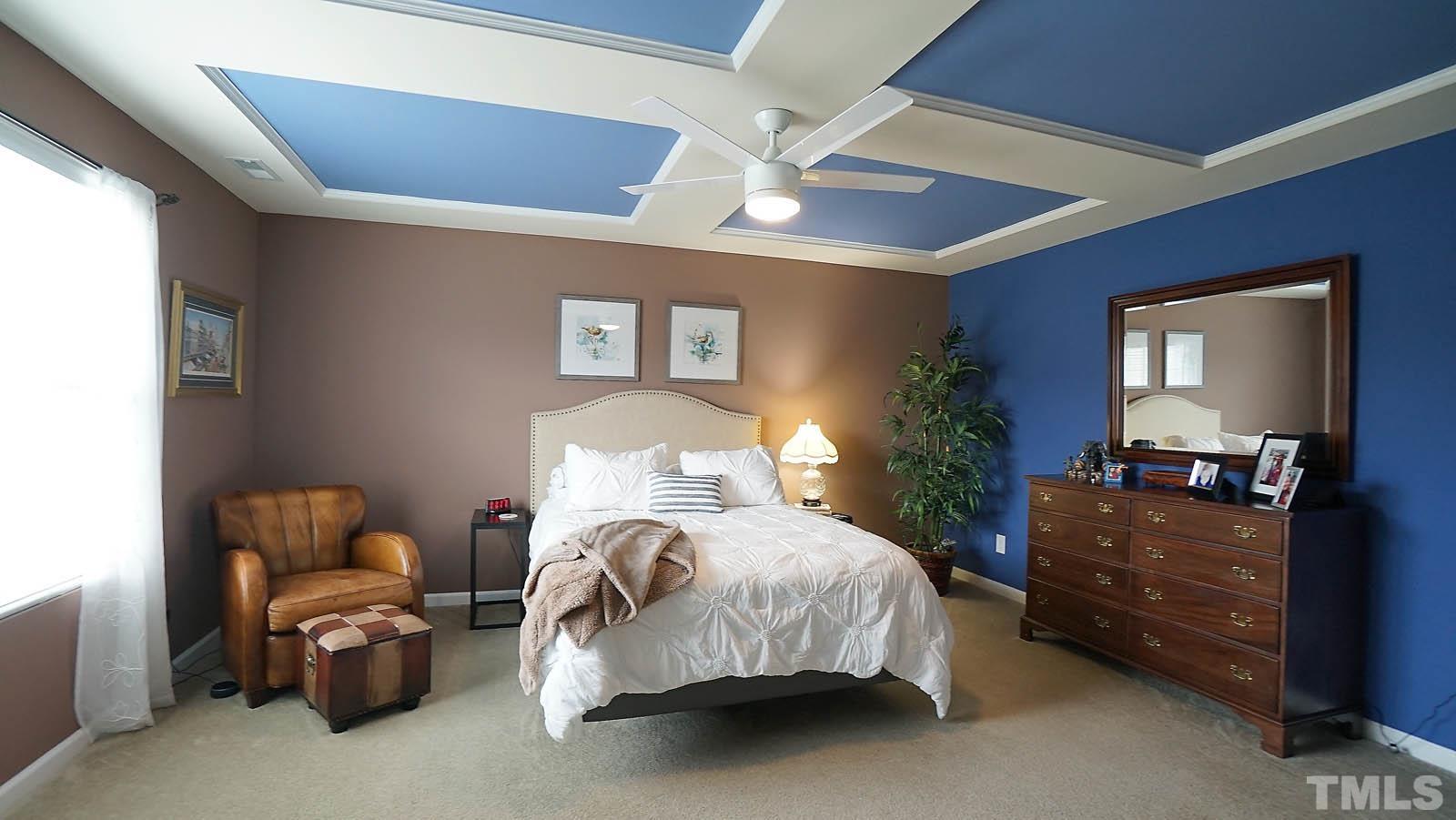 10115 Barnhart Way Raleigh, NC 27617 - Photo 39 of 60 a bedroom with a bed and furniture