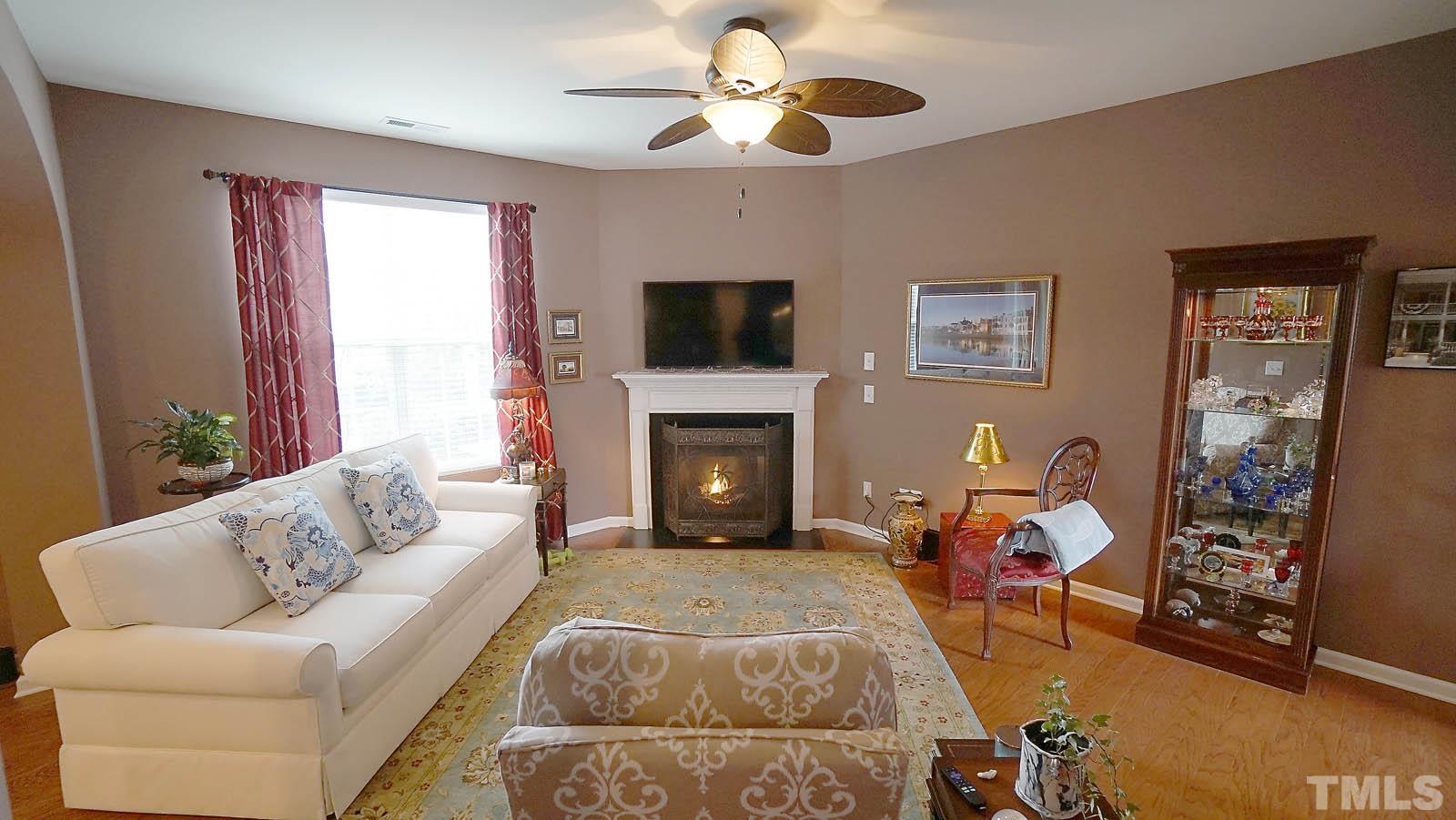 10115 Barnhart Way Raleigh, NC 27617 - Photo 4 of 60 a living room with furniture and a fireplace