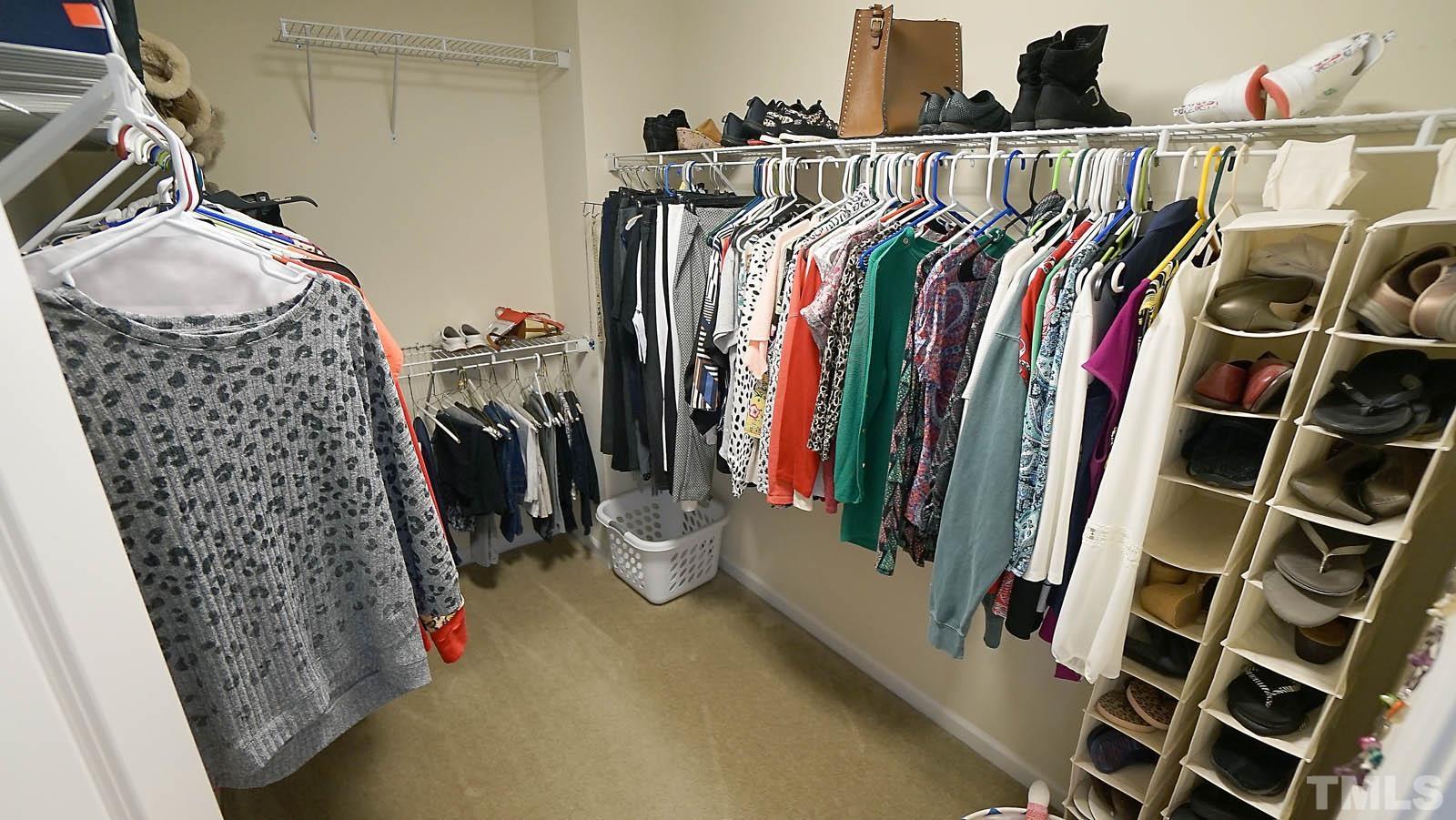 10115 Barnhart Way Raleigh, NC 27617 - Photo 42 of 60 a view of walk in closet with clothes and shoes