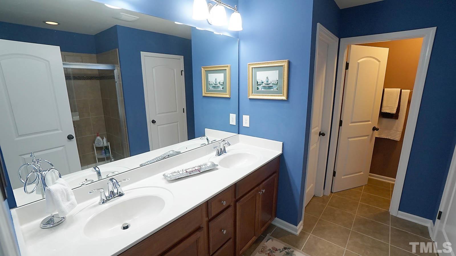 10115 Barnhart Way Raleigh, NC 27617 - Photo 44 of 60 a bathroom with a sink and a mirror