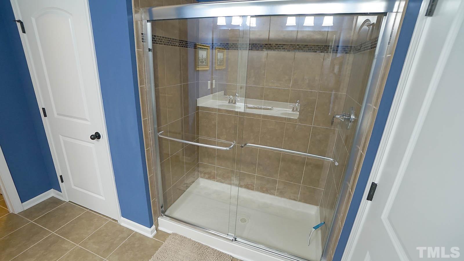 10115 Barnhart Way Raleigh, NC 27617 - Photo 45 of 60 a bathroom with a glass shower door