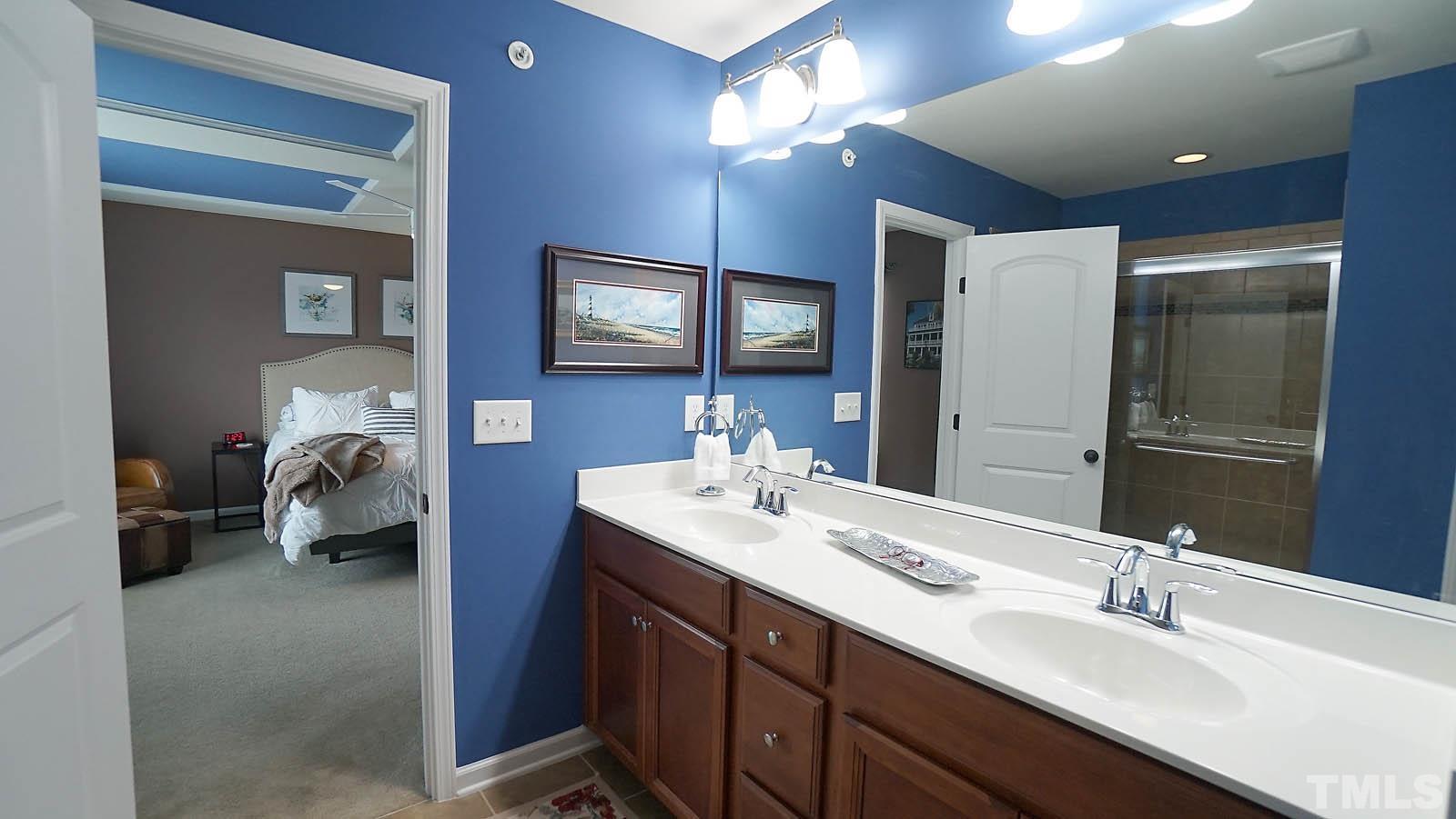 10115 Barnhart Way Raleigh, NC 27617 - Photo 47 of 60 a en suite bathroom with a double vanity sink and a mirror