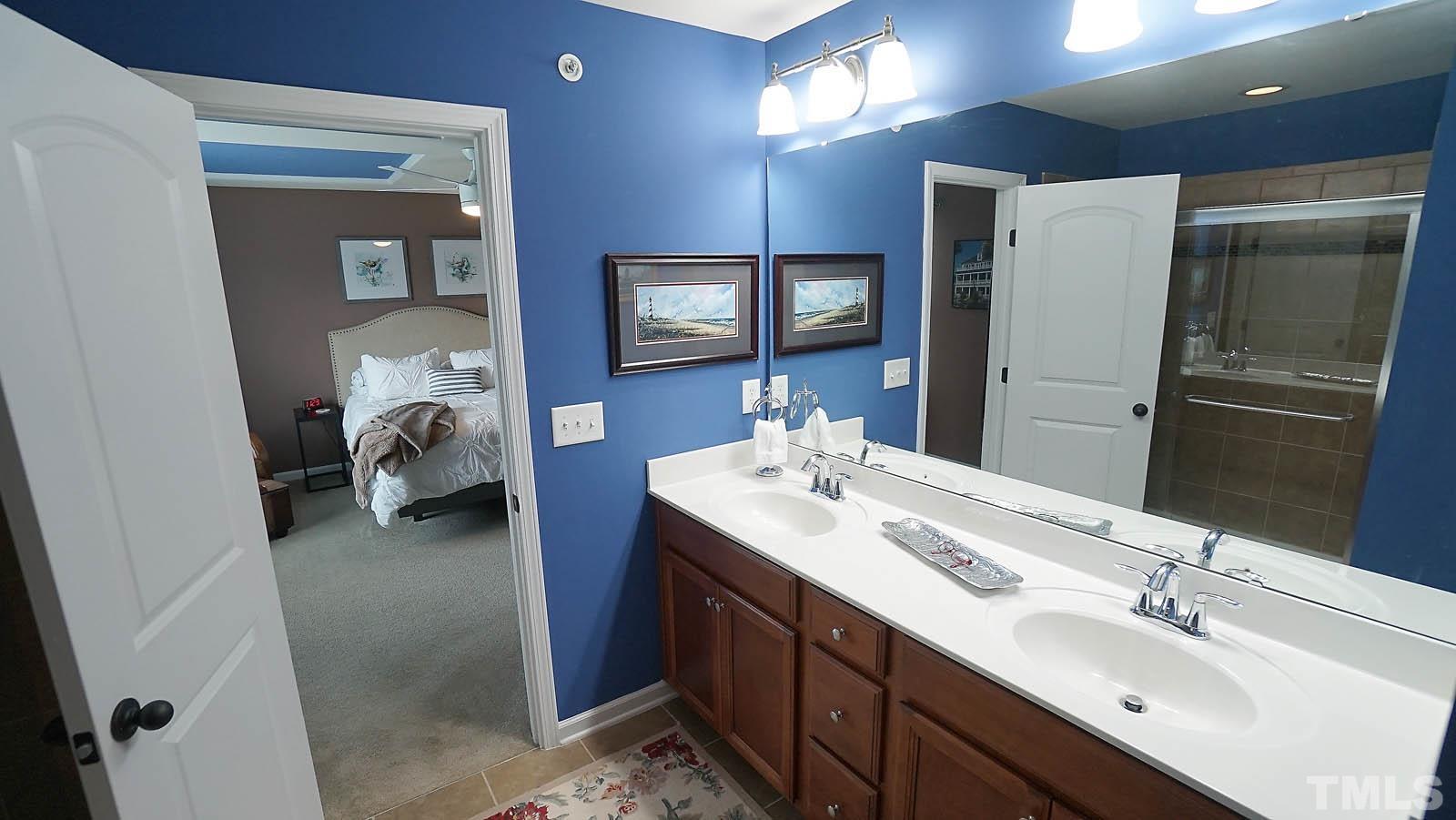 10115 Barnhart Way Raleigh, NC 27617 - Photo 48 of 60 a en suite bathroom with a double vanity sink and a mirror