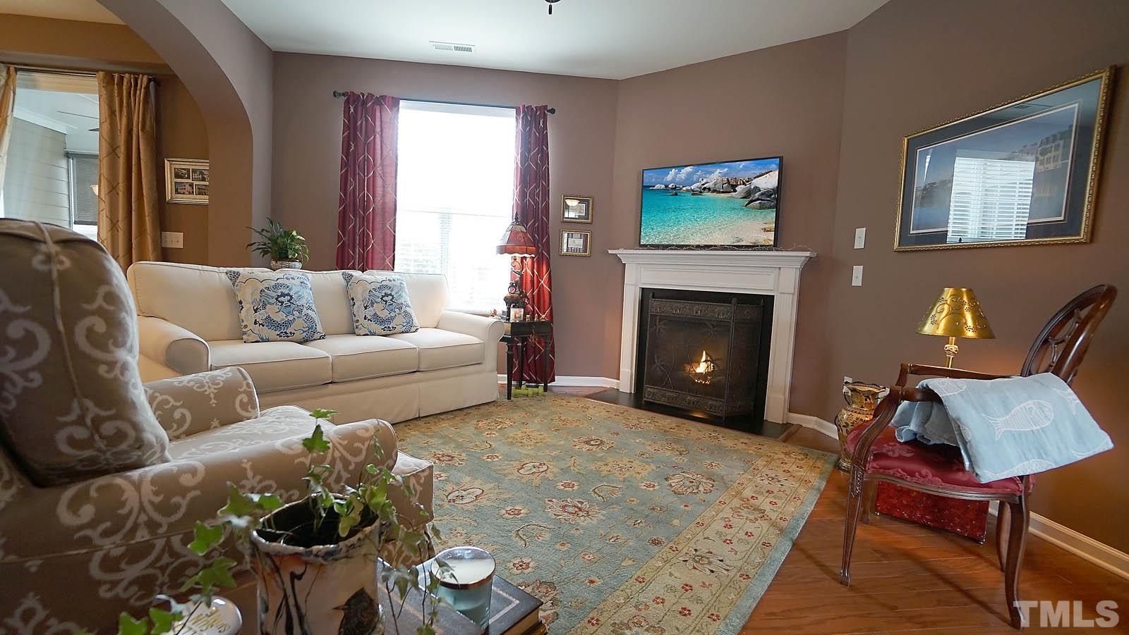 10115 Barnhart Way Raleigh, NC 27617 - Photo 5 of 60 a living room with furniture and a fireplace