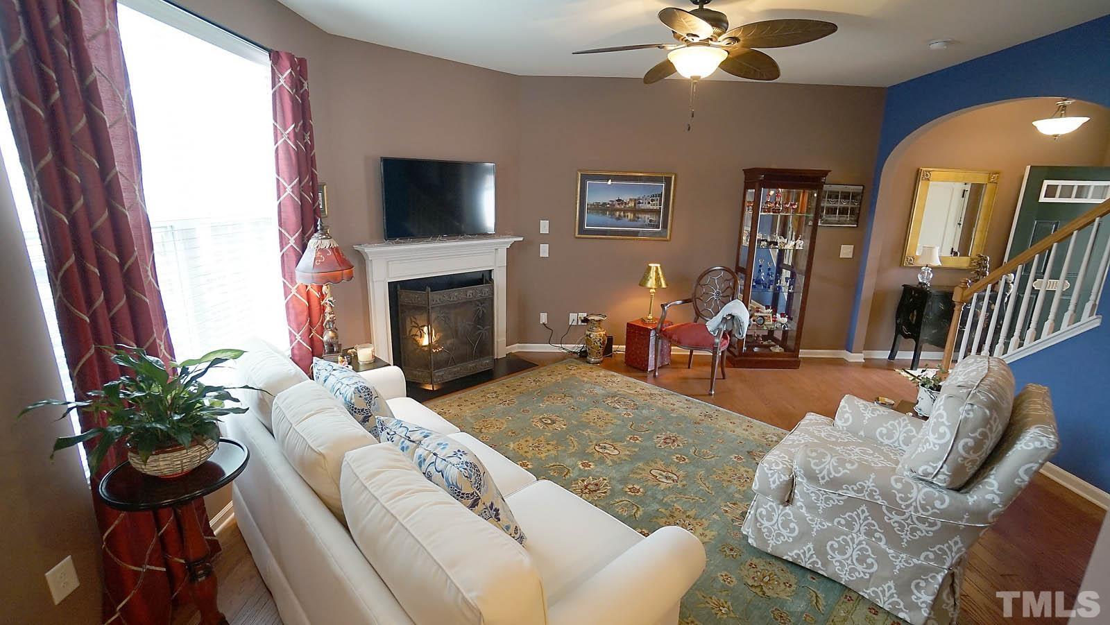 10115 Barnhart Way Raleigh, NC 27617 - Photo 8 of 60 a living room with furniture fireplace and potted plant
