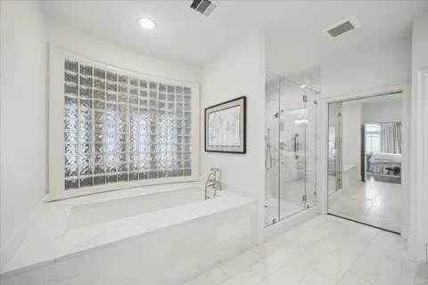 a spacious bathroom with a bathtub and a shower