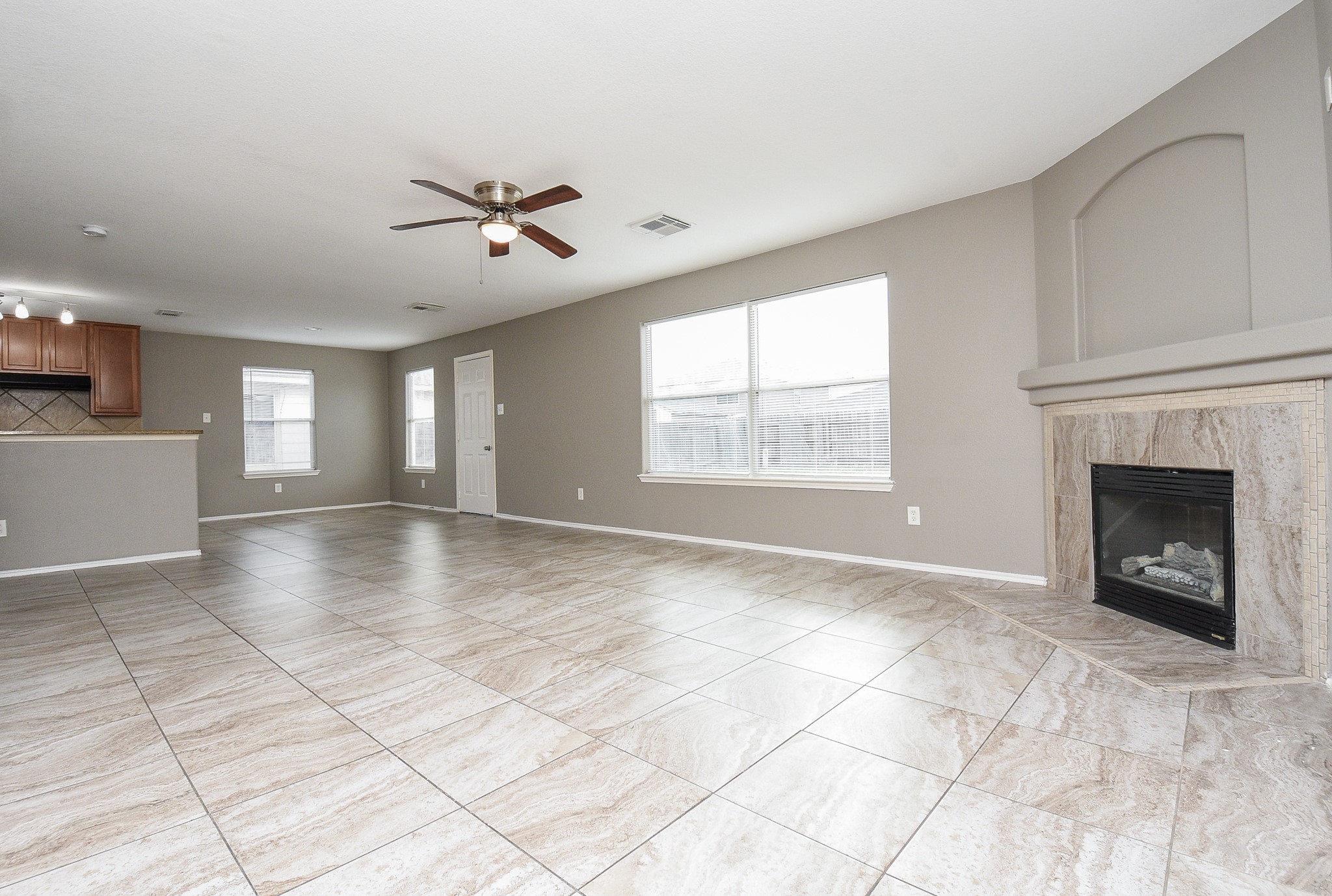 642 Kiley Drive Houston, TX 77073 - Photo 15 of 24 a view of a livingroom with a fireplace a ceiling fan and windows