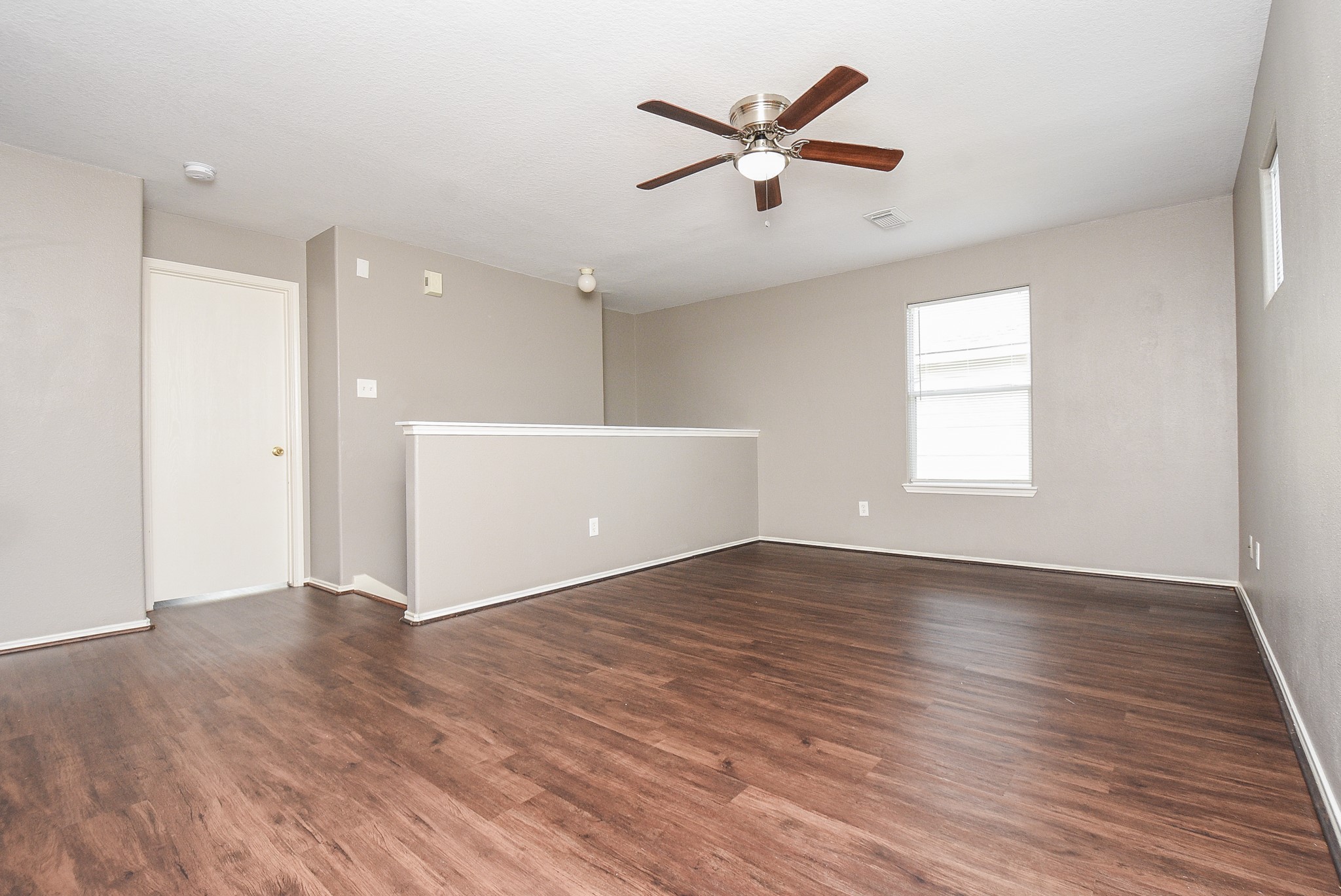 642 Kiley Drive Houston, TX 77073 - Photo 19 of 24 an empty room with wooden floor and windows