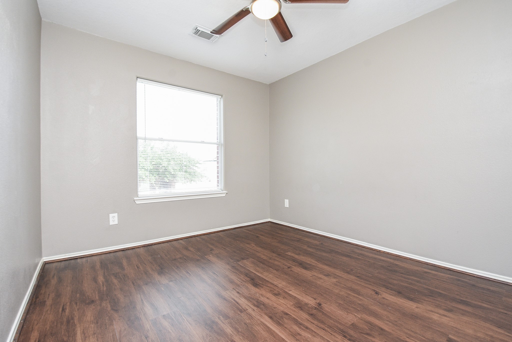 642 Kiley Drive Houston, TX 77073 - Photo 20 of 24 an empty room with a window and wooden floor