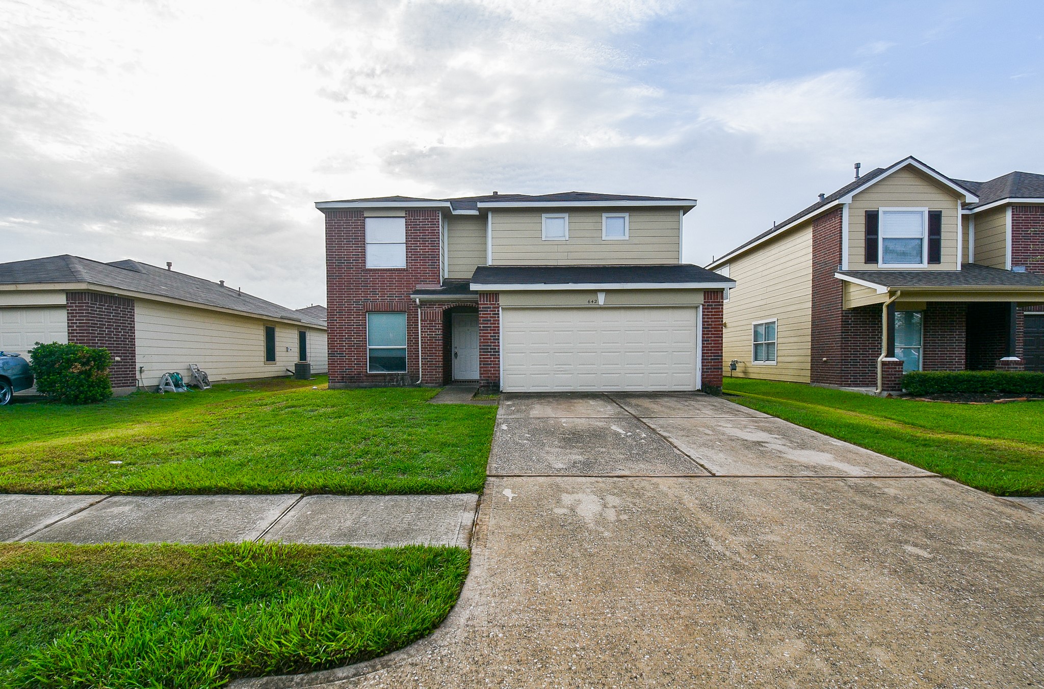 642 Kiley Drive Houston, TX 77073 - Photo 2 of 24 a front view of a house with a yard and garage