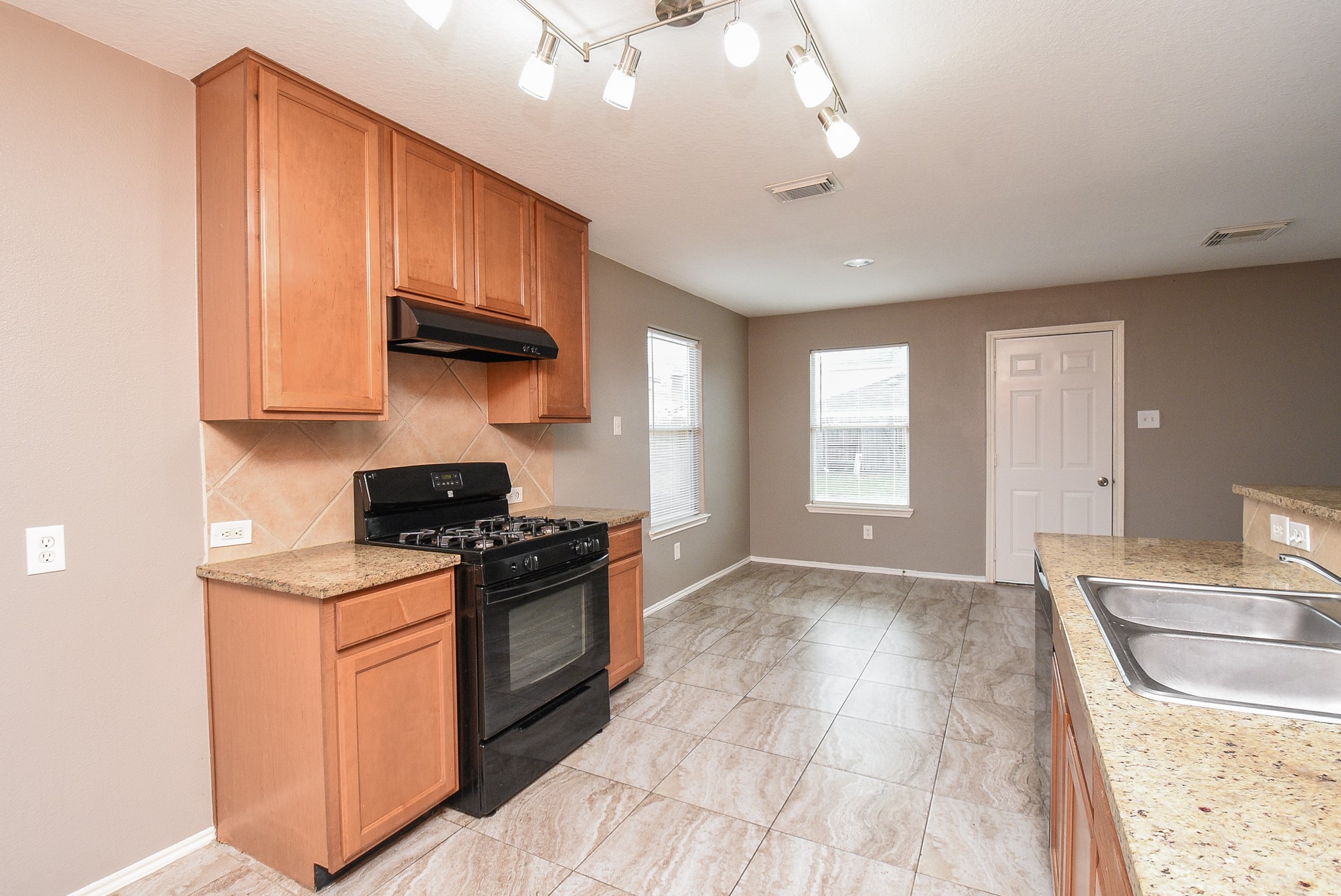 642 Kiley Drive Houston, TX 77073 - Photo 6 of 24 a kitchen with stainless steel appliances granite countertop a stove a sink and a microwave
