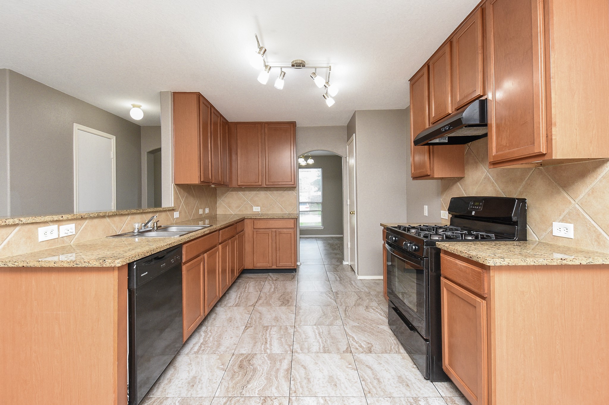 642 Kiley Drive Houston, TX 77073 - Photo 7 of 24 a large kitchen with stainless steel appliances granite countertop a stove a sink dishwasher and a refrigerator