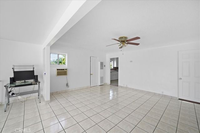 a view of a livingroom with a dinning area hardwood floor and a ceiling fan