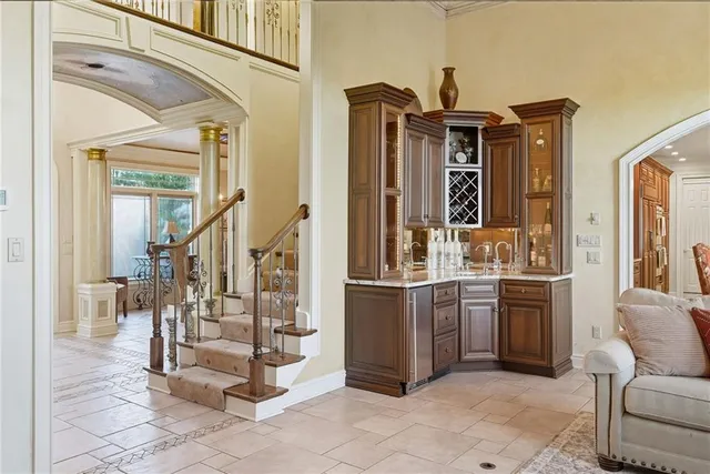 a view of living room filled with furniture and large windows