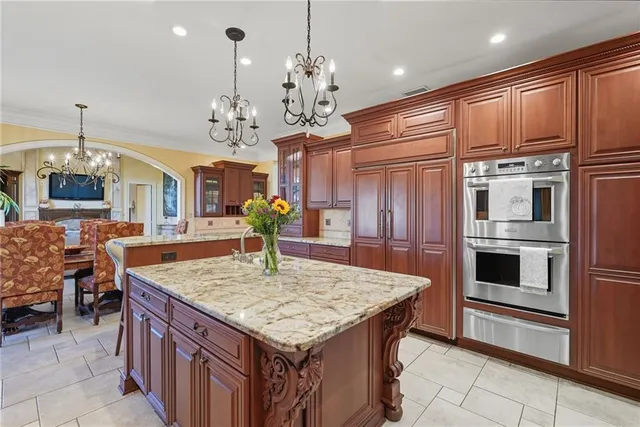 a kitchen with center island table and chairs in it