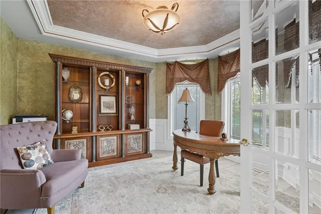 a living room with furniture a piano and a large window