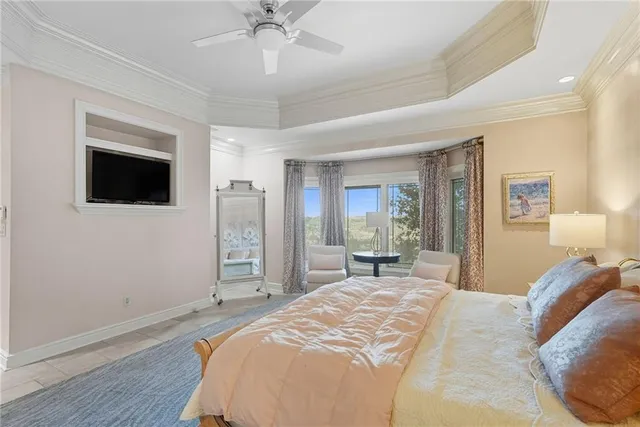 a spacious bedroom with a bed and a chandelier
