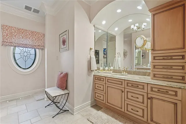 a spacious bathroom with a granite countertop toilet a sink and a mirror