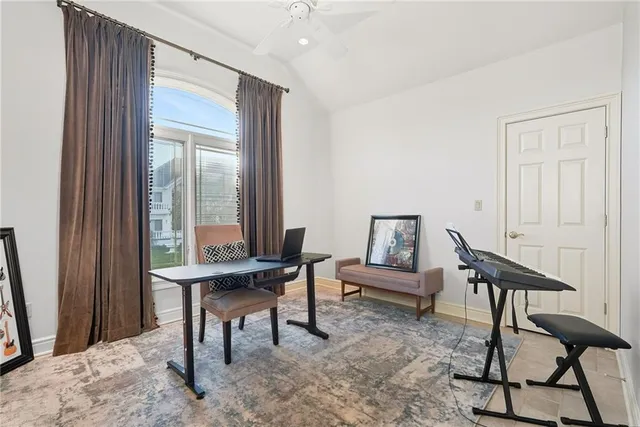 a view of a workspace with furniture and a window