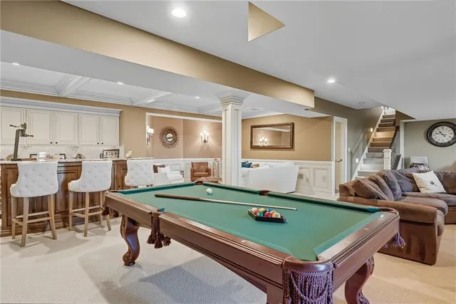 a room with pool table and windows