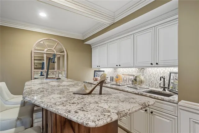 a kitchen with a table chairs and cabinets