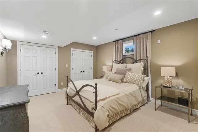 a spacious bedroom with a bed and a couch