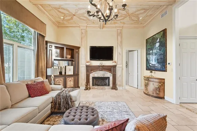 a living room with furniture a fireplace and a flat screen tv