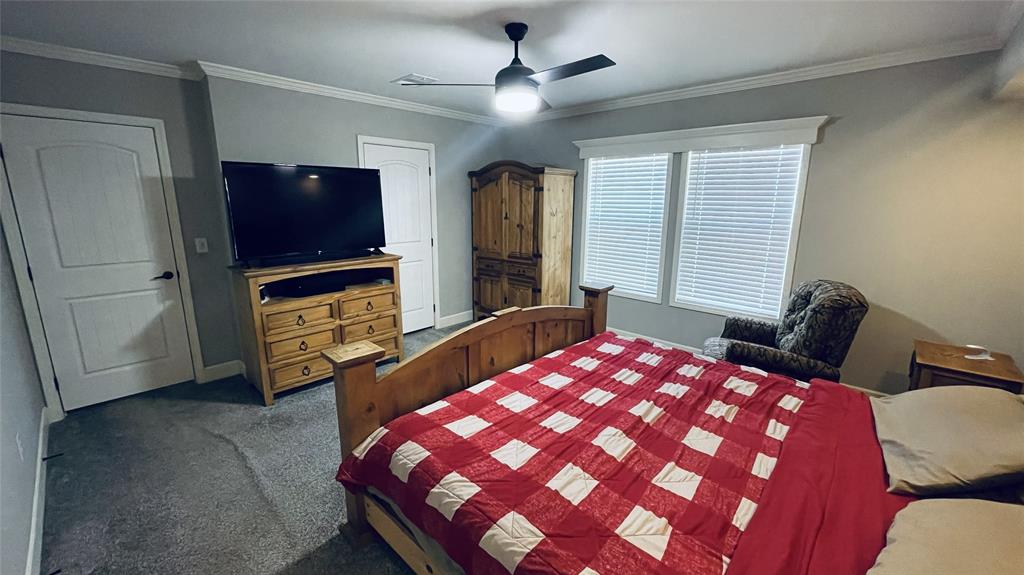 8394 Lake Road Mansfield, TX 76063 - Photo 16 of 22 a bedroom with a bed and a flat screen tv