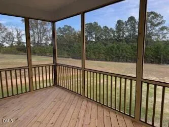 a view of a balcony with wooden floor