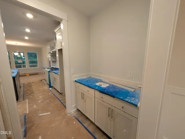 a kitchen with stainless steel appliances granite countertop table chairs sink and cabinets