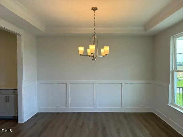 a view of a room with wooden floor and windows