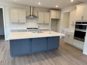 a kitchen with a sink cabinets and stainless steel appliances