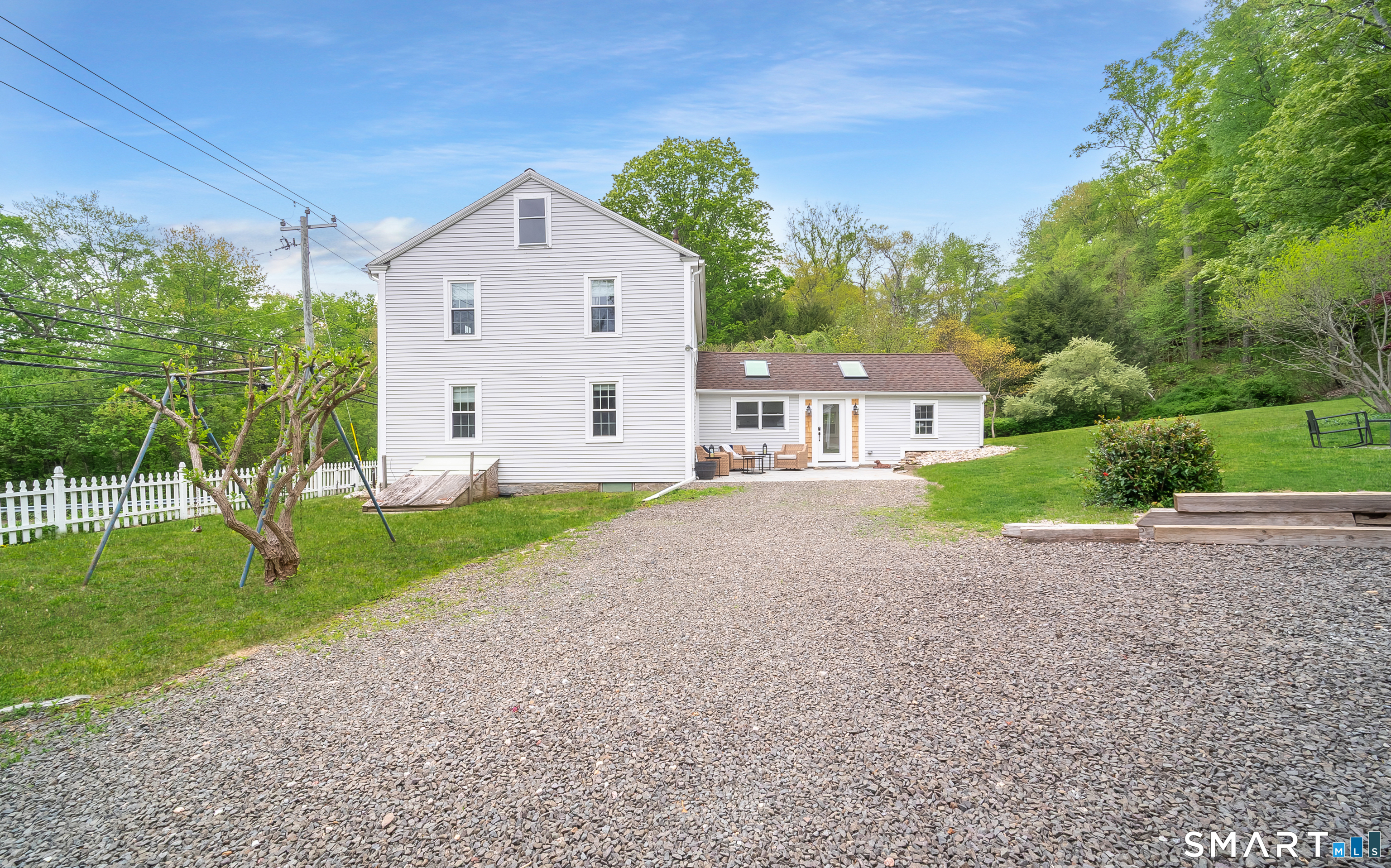 230 Killingworth Road Haddam, CT 06441 - Photo 32 of 36 a view of a white house with a yard and plants