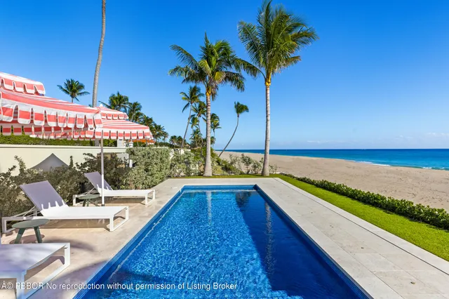 a view of a chairs and table in patio with a swimming pool