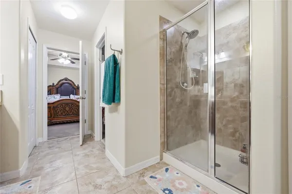 a bathroom with a glass shower door and mirror