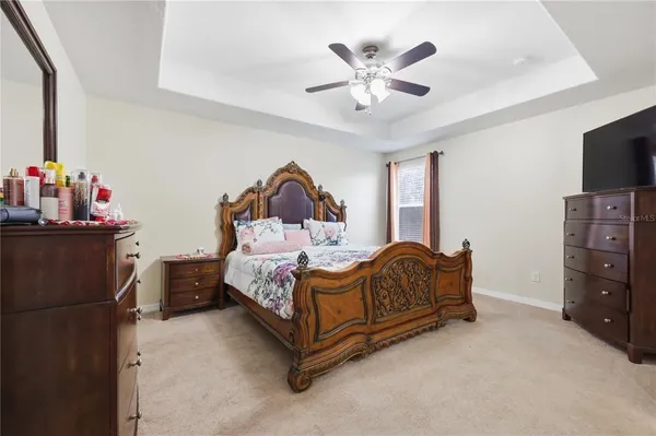 a bedroom with a bed and a chandelier