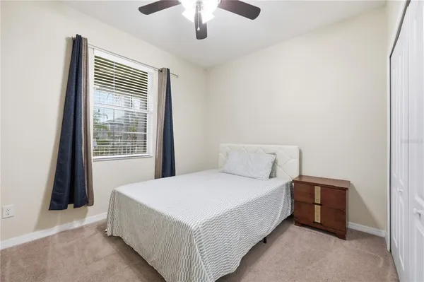 a bedroom with furniture and a large window