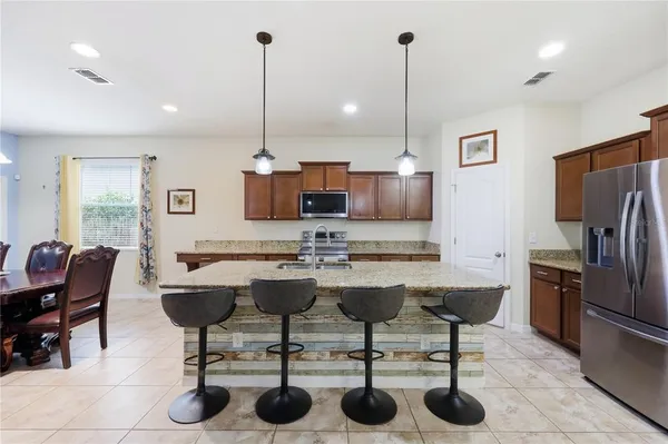 a view of a hallway with wooden floor and furniture
