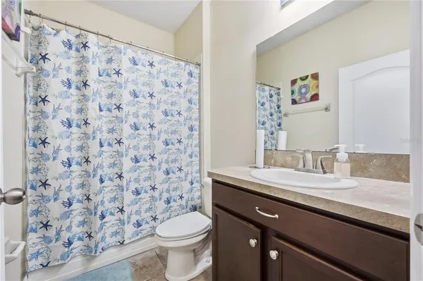 a view of a hallway with wooden floor windows and a rug