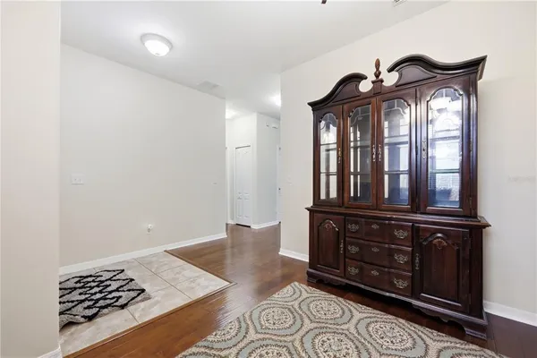 a living room with furniture a chandelier and a window