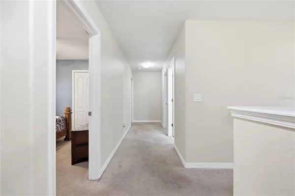 a view of a hallway with an entryway door