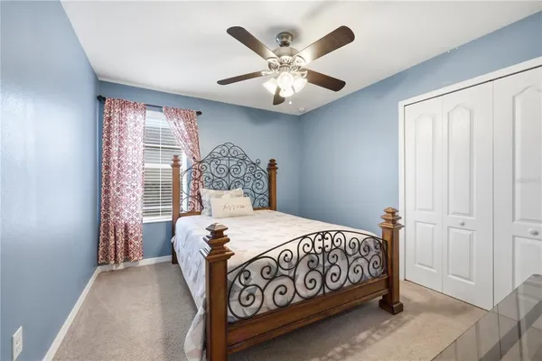 a bedroom with a large bed and a chandelier